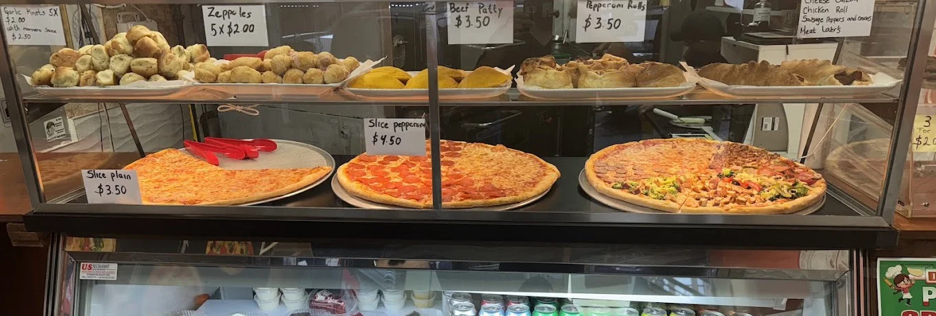 Slices and snacks in the case at Daisy's Pizza 174th St