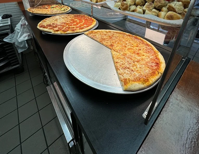 Fresh pies on the counter at Daisy's Pizza 174th St